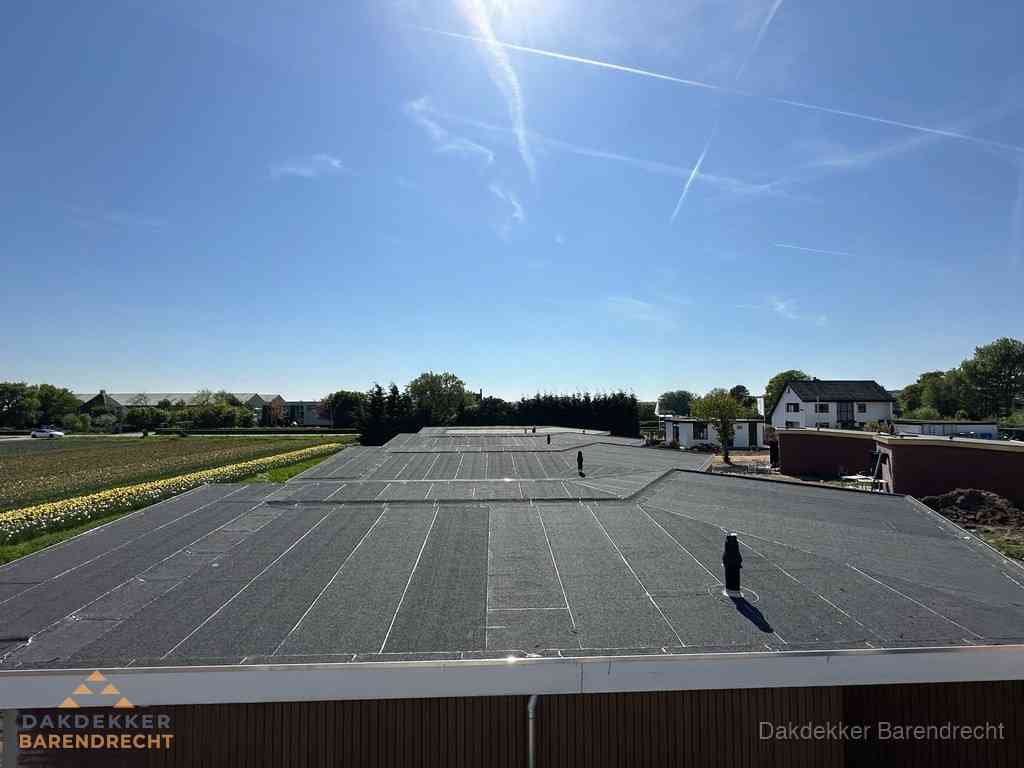 Groot plat dak met bitumen dakbedekking op bedrijfspand in Barendrecht