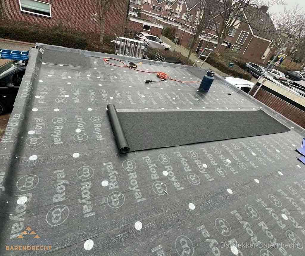Dakdekker aan het werk met gasbrander op plat bitumen dak in Barendrecht
